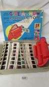 A Chad Valley Give a Show battery operated projector with 56 colour slides giving shows of 8