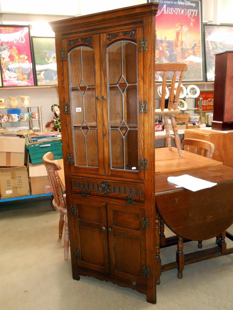 An oak corner cupboard with leaded glass doors 72cm x 35cm x height 181cm