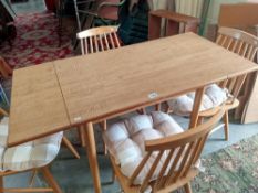 A teak style extending table with 4 ercol style chairs