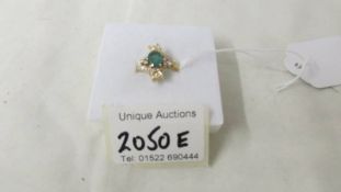 An 18ct gold diamond and emerald ring (tests as 18ct), weight 4.8 grams, size O.