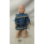 A porcelain headed doll marked K & R - 101, missing wig, 38 cm.