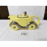 A yellow racing car teapot.