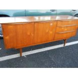 A 3 door teak sideboard