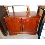 A dark wood stained 2 door cupboard/tv stand 80cm x 44cm x height 60cm