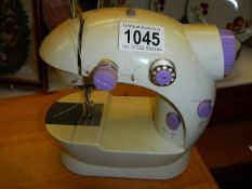 A vintage child's battery operated sewing machine.