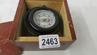 A boxed small marine compass.