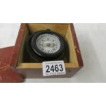A boxed small marine compass.