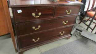 A 2 over 2 mahogany chest of drawers.