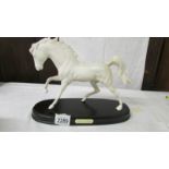 A Beswick 'Spirit of Flight' white horse on base.