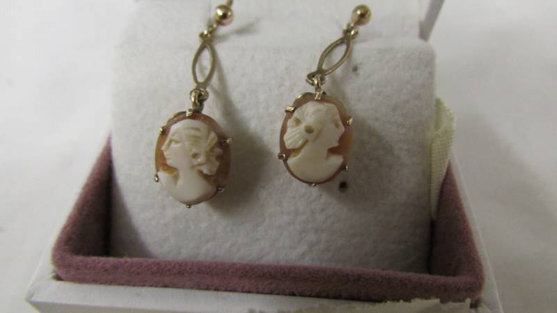 A pair of cameo ear pendants designed as profiles of young women in 9 carat gold. - Image 2 of 2