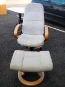 A white / fawn leather chair with height adjust and macthing footstool