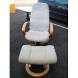 A white / fawn leather chair with height adjust and macthing footstool