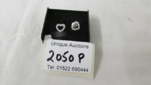 A pair of 18ct white gold heart shaped diamond earrings, (half carat in total).
