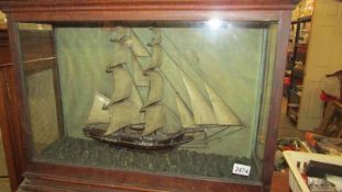 A cased model of a tall ship.