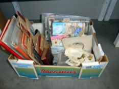 An interesting box of ephemera including vintage postcards and photographs, cigarette cards, silks,