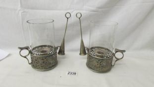 A pair of 19th century silver plate candleholders with snuffers and chimneys.