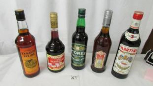 5 bottles of alcohol being Caribbean dark rum, Grenadine, Stones original green ginger wine,