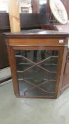 A mahogany astragal glazed corner cupboard.