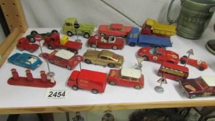 A mixed lot of die cast vehicles, mainly Corgi together with road signs and petrol pumps.