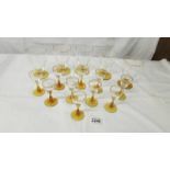 Five gold decorated lemonade glasses and 10 liquor glasses with amber glass stems.