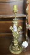 A brass table lamp featuring cherubs.