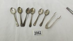 A set of 6 golf related silver tea spoons and silver sugar nips.