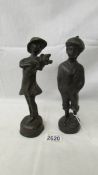 A pair of bronze figures of a boy and girl, 23 cm tall.