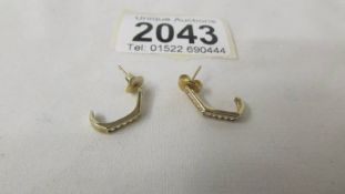 A pair of 9ct gold earrings set stones, 1.4 grams.