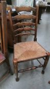 A period oak ladderback chair with rush seat.