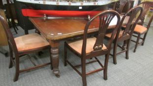 A mahogany extending dining table with one leaf, 2 carvers and 4 dining chairs.