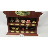 A collection of 10 Steiff miniature bears with display shelf.