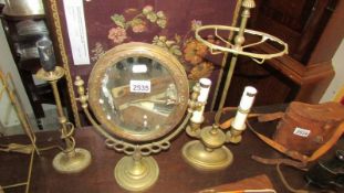 2 brass table lamps and a brass framed mirror.