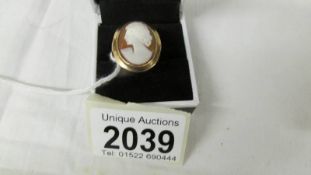 A 9ct gold cameo ring with female profile, size P half.