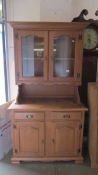 A pine glazed top dresser with 2 drawers and 2 cupboards to base.