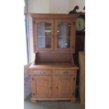 A pine glazed top dresser with 2 drawers and 2 cupboards to base.