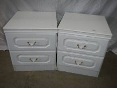 A pair of 2 drawer white bedside chests.