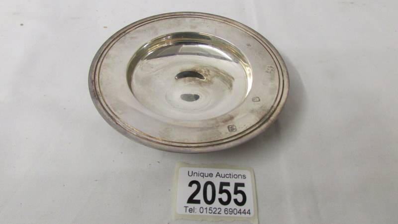 A hall marked Comyns of London silver dish, 12 cm diameter, 116 grams.