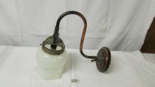 An early 20th century gas wall light with opaque glass shade.