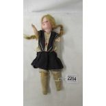 A German porcelain headed doll marked Germany 12/0, 29 cm.