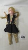 A German porcelain headed doll marked Germany 12/0, 29 cm.