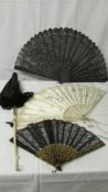 Two black lace fans, a silk fan and a folding parasol, all in good condition.