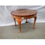 A circular pie crust edge coffee table.