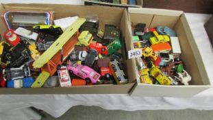 2 boxes of assorted play worn die cast vehicles.