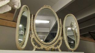 An oval framed triple 'shabby chic' dressing table mirror.