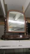 A mahogany toilet mirror with barley twist supports.