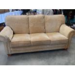 A 3 seater beige draylon quality settee on oak legs