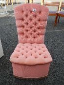 A pink deep button velour bedroom chair