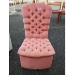 A pink deep button velour bedroom chair