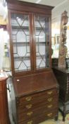 A good Edwardian mahogany inlaid bureau bookcase.