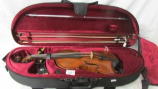 An old violin with 2 bows in a modern case (no makers marks).